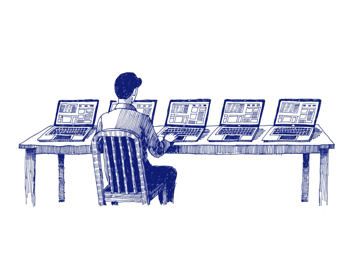 A person seen from behind at a long desk with five identical laptops in a row, each showing the same dashboard in slightly different colours, the whole scene drawn with wide empty margins on every side.
